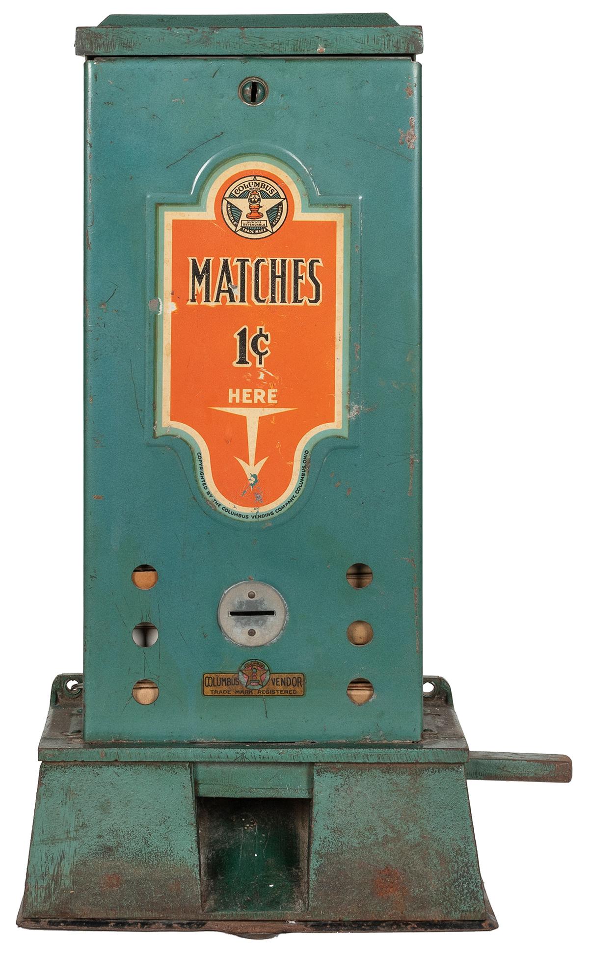 Columbus Matches 1 Cent Vending Machine. Circa 1920s.: Columbus Matches 1 Cent Vending Machine. Circa 1920s. Cast iron base with tin upper body, painted green; original paint and decals. Match strikers on top of base plate. South Dakota vending license on