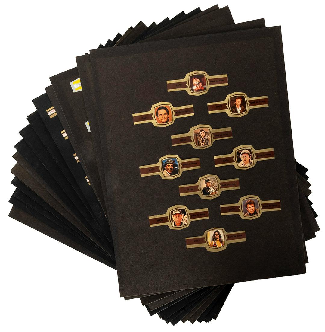 [TOBACCIANA]. Cigar Band Collection. Holland,: [TOBACCIANA]. Cigar Band Collection. Holland, 1960s-70s. Mounted collection of cigar bands in complete sets, including Cogetama Indian Chiefs (24) Smoking Pipes (24), “Dallas” TV series (2