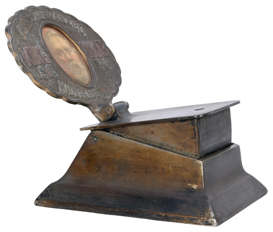 [TOBACCIANA]. King Oscar Cigar Cutter. Nickel plated: [TOBACCIANA]. King Oscar Cigar Cutter. Nickel plated cast iron cutter advertising 5 cent cigars with a portrait at the center of the upright medallion. 8 x 8 x 5”. Working.