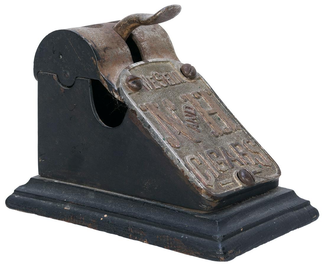 [TOBACCIANA]. N & H Cigar Co. Cigar Cutter. Circa: [TOBACCIANA]. N & H Cigar Co. Cigar Cutter. Circa 1890s. Cigar cutter with two different size holes. Length, 4 ½”.