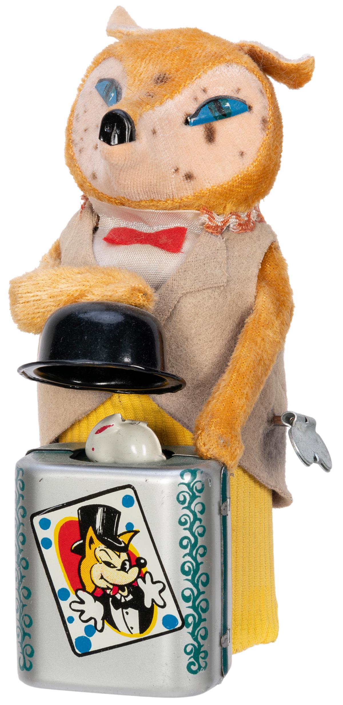 T.N. Fox the Magician Wind-Up Toy. Japanese wind-up: T.N. Fox the Magician Wind-Up Toy. Japanese wind-up toy, lithographed tin, plastic, and fabric. The fox vanishes a rabbit from underneath a top hat. Face spotted. Approx. height 6 ¼”. Worki
