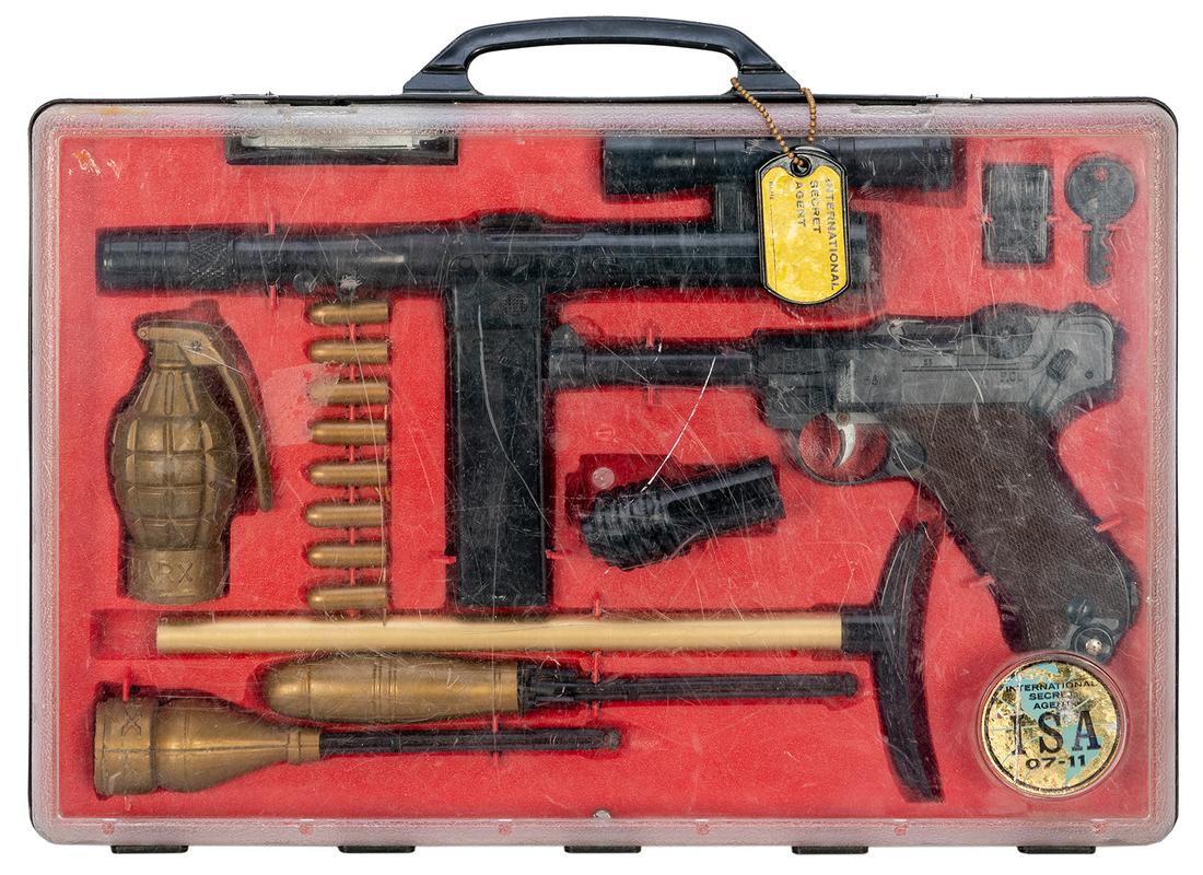 Marx International Secret Agent 07-11 Set in Case. Circa 19...: Marx International Secret Agent 07-11 Set in Case. Circa 1960s. Plastic toy gun set, complete in original box with dog-tags and key retained on handle. Sticker/decal worn, scratching to clear cover. 9