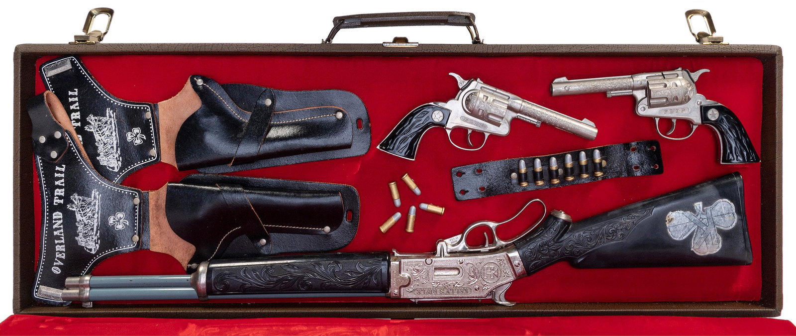 Hubley Kelly and Flip Overland Trail Rifle and Pistol Holst...: Hubley Kelly and Flip Overland Trail Rifle and Pistol Holster Set in Hard Case. Hubley, ca. 1950s. Plush-lined clasping case containing a Hubley Kelly Rifle, two Flip revolvers, two Overland Trail hol