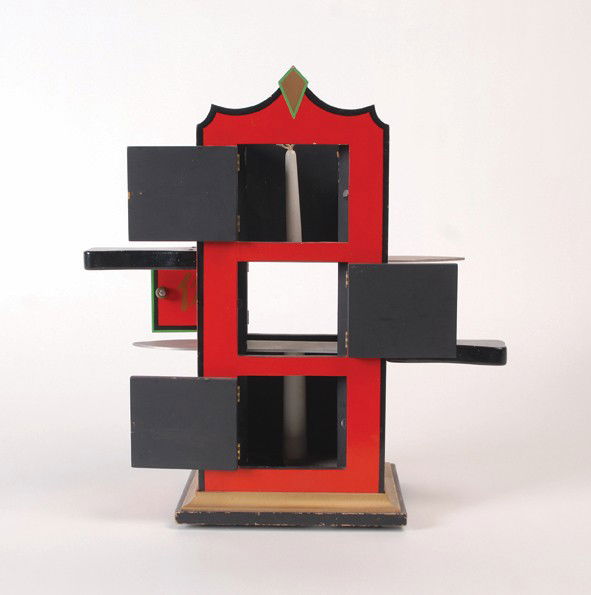 Chinese Flame Clock. Alhambra, Milson Worth: Chinese Flame Clock. Alhambra, Milson Worth, ca. 1970. A candle is placed into a tall cabinet decorated with an Asian motif. The magician cuts through the cabinet – and candle with two large blades.