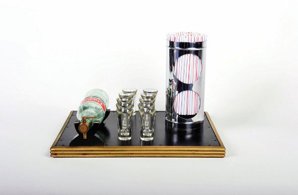 Coke of Plenty. Colon, Abbott's Magic: Coke of Plenty. Colon, Abbott's Magic Company, ca. 1960. The magician displays an empty Coca Cola bottle and lays it on two wooden trestles on a wooden tray. A brass spigot is inserted into the neck o