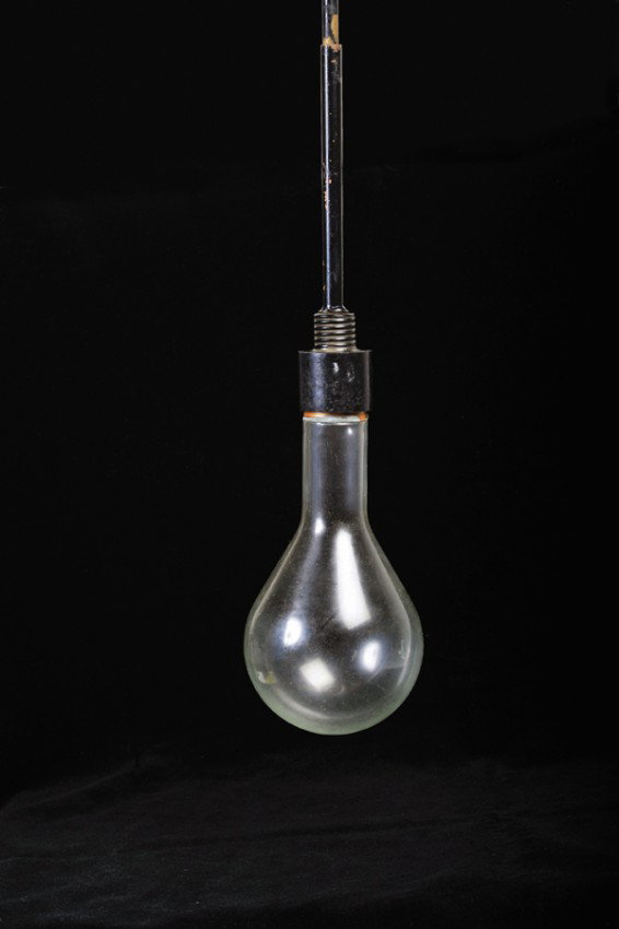 Milk in Lightbulb. American, ca. 1965: Milk in Lightbulb. American, ca. 1965. An oversized light bulb is lit and held by an assistant. Across the stage, the magician pours a quantity of milk into a paper cone. The milk vanishes from the co
