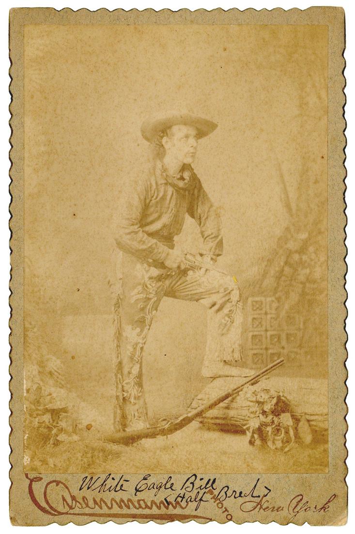 Cabinet photo of White Eagle Bill. New York: Charles Eisenm...: Cabinet photo of White Eagle Bill. New York: Charles Eisenmann, ca. 1890s. Full-length portrait of the performer with a revolver and rifle at his feet, dressed in Western attire. 6 3/8 x 4 ¼̶