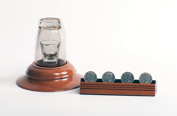 Copenetro. Klinecraft, ca. 1949: Copenetro. Indiana Pennsylvania, Klinecraft, ca. 1949. A shot glass rests on a small wooden pedestal and is covered by a clear tumbler. The magician vanishes four half dollars and they reappear in the