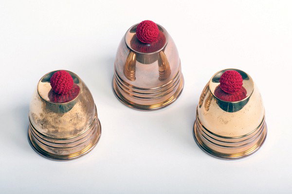 Johnson Products Cups and Balls. Arcadia California: Johnson Products Cups and Balls. Arcadia California, Johnson Products, ca. 2000. Set of three machine turned cups for the classic magic trick. Includes black velvet bag and crocheted balls. Hallmarked