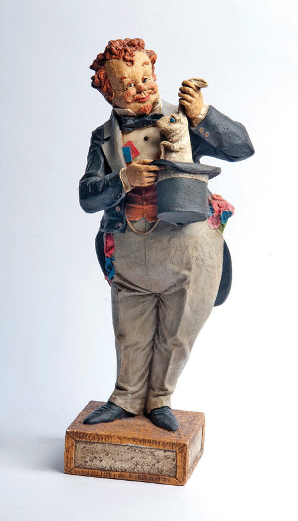 Painted statuette of a magician producing rabbit: Painted statuette of a magician pulling rabbit from a hat. American, ca. 1975. Whimsical hand-painted statuette of a magician pulling a rabbit from a hat. Cast plaster. 23" high. Base has two unobtrus