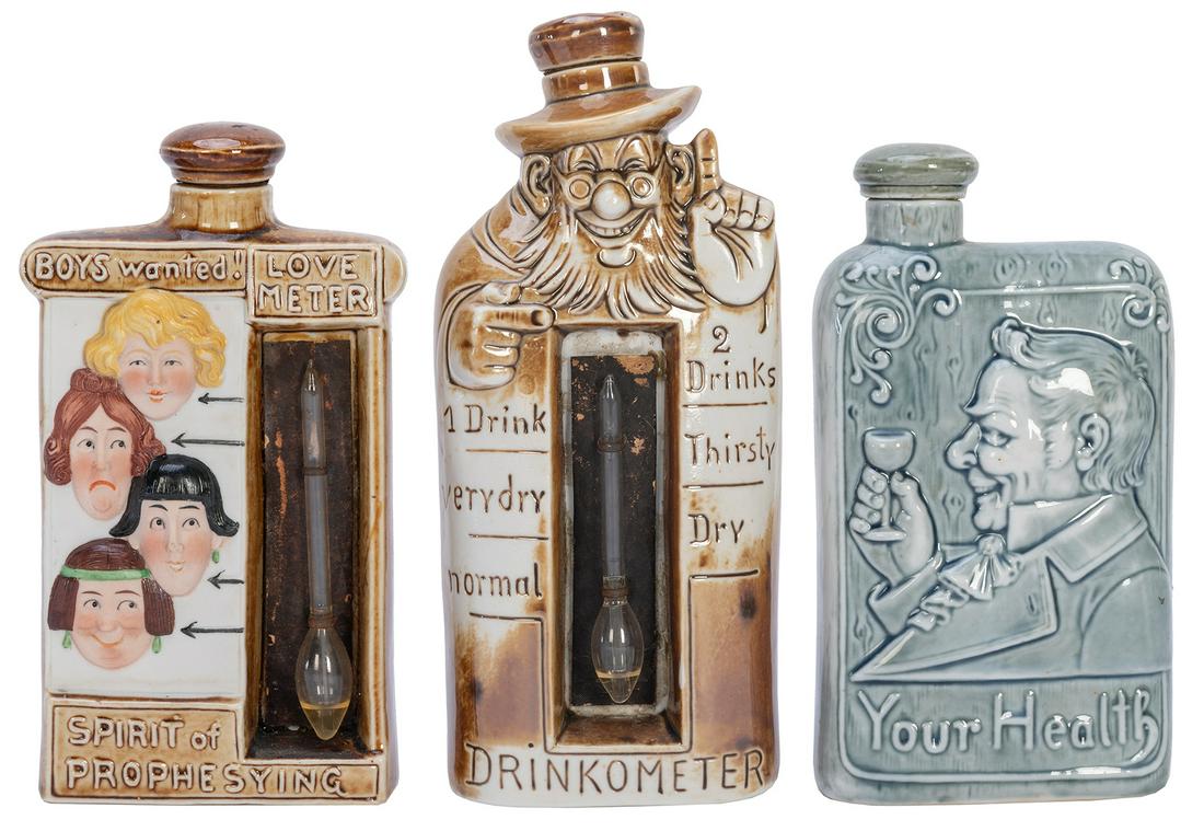 Group of 3 “Drinkometer” painted ceramic flasks. [Germany and elsewhere, n.d.]. Two: Group of 3 “Drinkometer” painted ceramic flasks. [Germany and elsewhere, n.d.]. Two ceramic “Drinkometer” flasks with novelty, liquid-filled, glass tubes; one “Drinkomete
