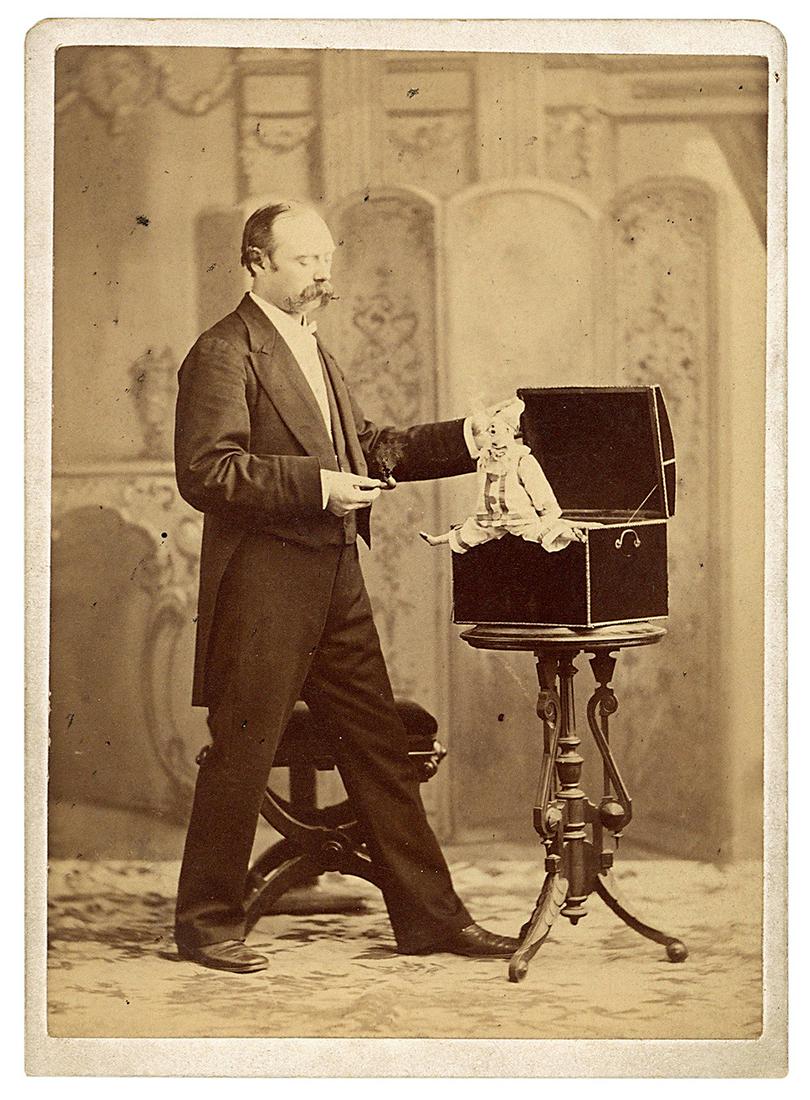 HELLER, Robert (William Henry Palmer, 1826 – 78). Robert He...: HELLER, Robert (William Henry Palmer, 1826 – 78). Robert Heller and the Harlequin. Circa 1870. Sepia tone full-length albumen photograph of the famed conjuror, humorist, and pianist presenting a