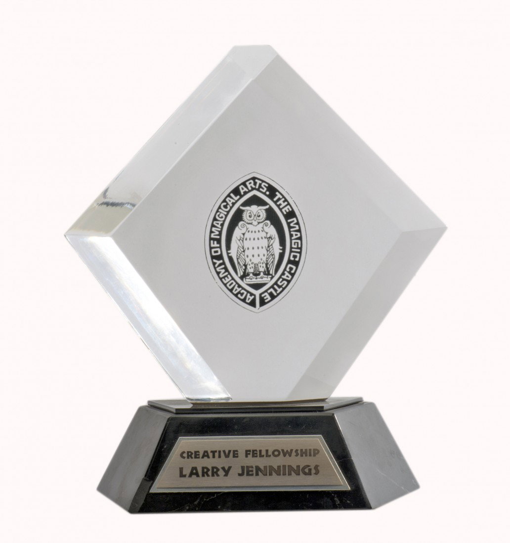 Larry Jennings' Creative Fellowship Award: Jennings, Larry. Larry Jennings' Creative Fellowship Award. Heavy Lucite and marble award presented to Jennings by the Academy of Magical Arts (The Magic Castle) in 1994. Bearing his name and the AMA 