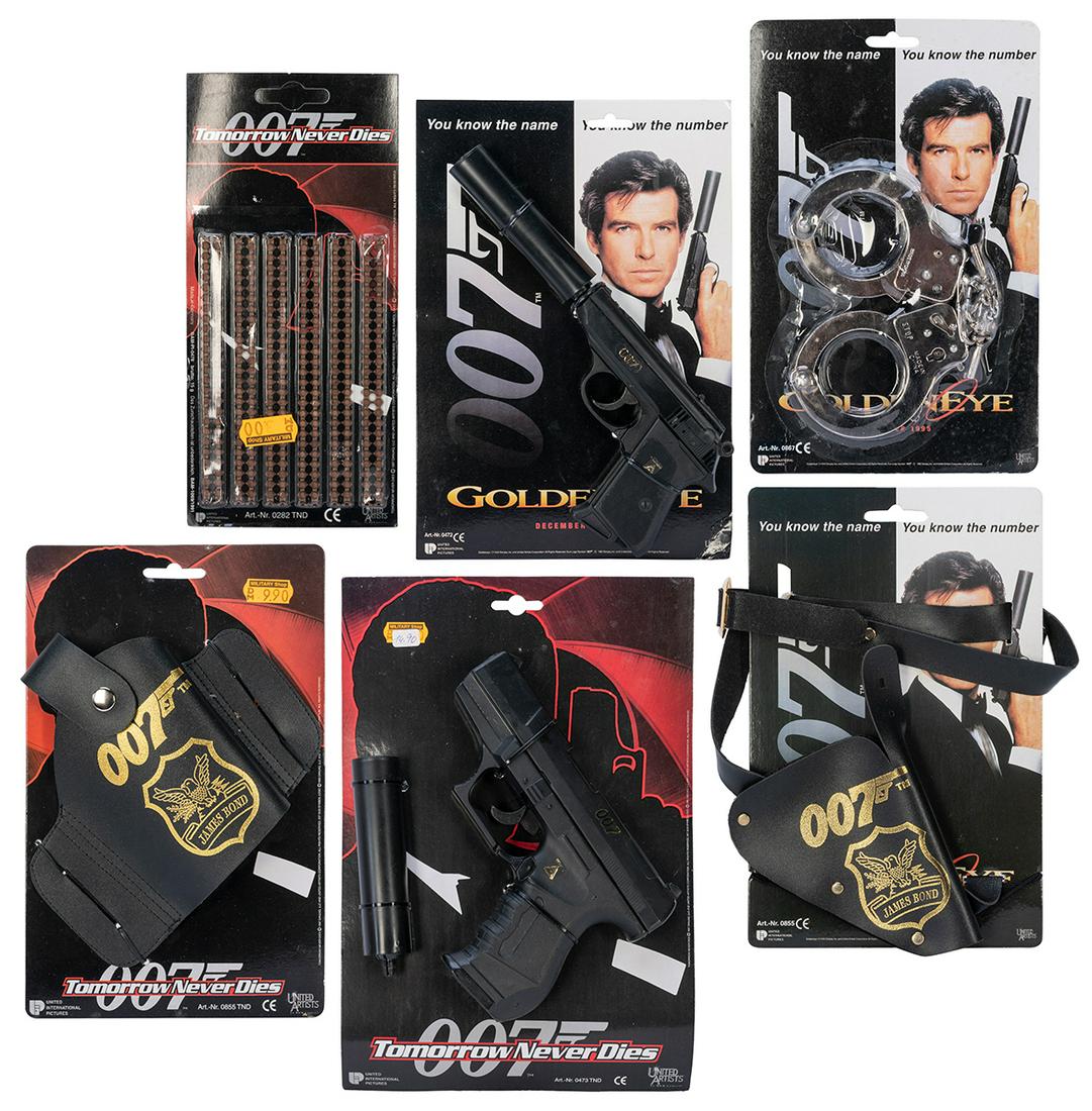 Group of 6 James Bond toys by United Artists, all in origin...: Group of 6 James Bond toys by United Artists, all in original packaging. [Germany: Wicke and Umarex for United Artists, 1990s]. Including Goldeneye OO7 James Bond holster, Goldeneye 007 metal handcuff
