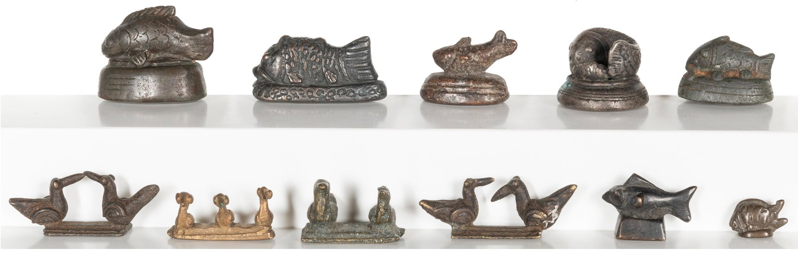 A group of 11 graduated metal fish and bird opium weights. ... (1 of 1)