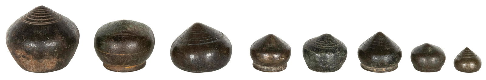 A group of 8 graduated circular onion-like opium weights. [... (1 of 1)
