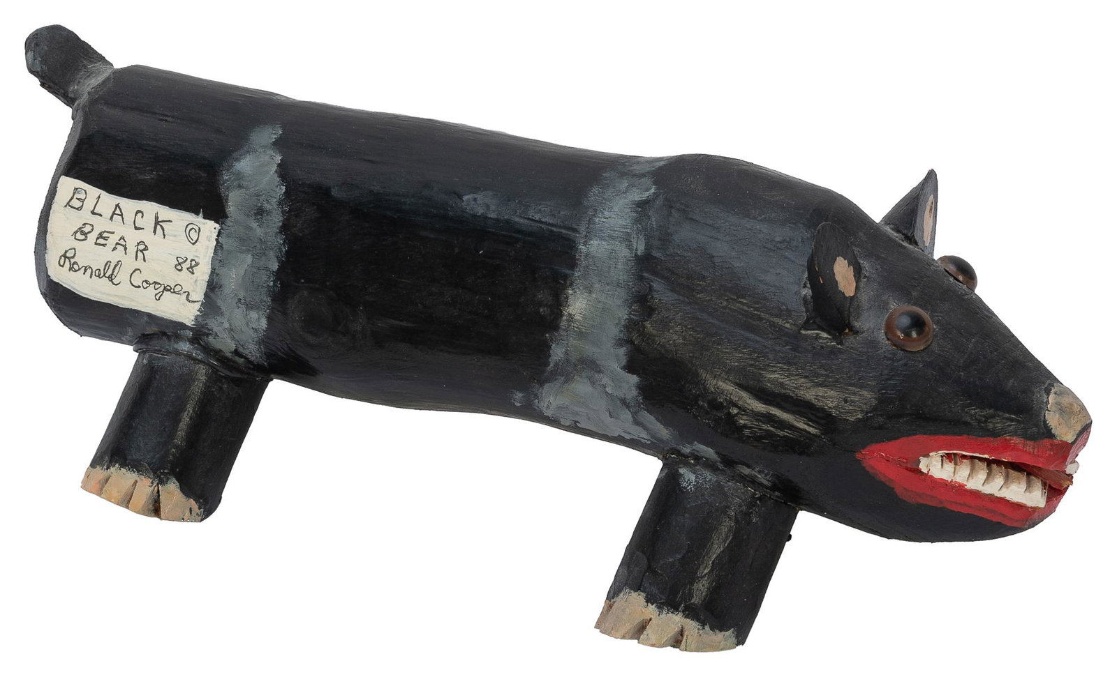 COOPER, Ronald (American, b. 1943). Black Bear. 1988. Acryl...: COOPER, Ronald (American, b. 1943). Black Bear. 1988. Acrylic on hand-carved wood, with glass eyes. Signed by the artist on the bear’s right side. 6 h x 15 w x 6 ½” d. Good condition.