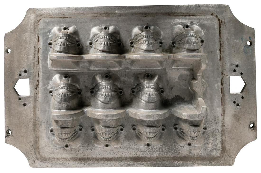 Cast Metal Dental Mold. (American, 20th century). Mold for ...: Cast Metal Dental Mold. (American, 20th century). Mold for 11 dentures, top and bottom. 16 x 25 x 3 ½” on ½” thick sheet. Each mold has “Pat. Pend.” on the verso. Som