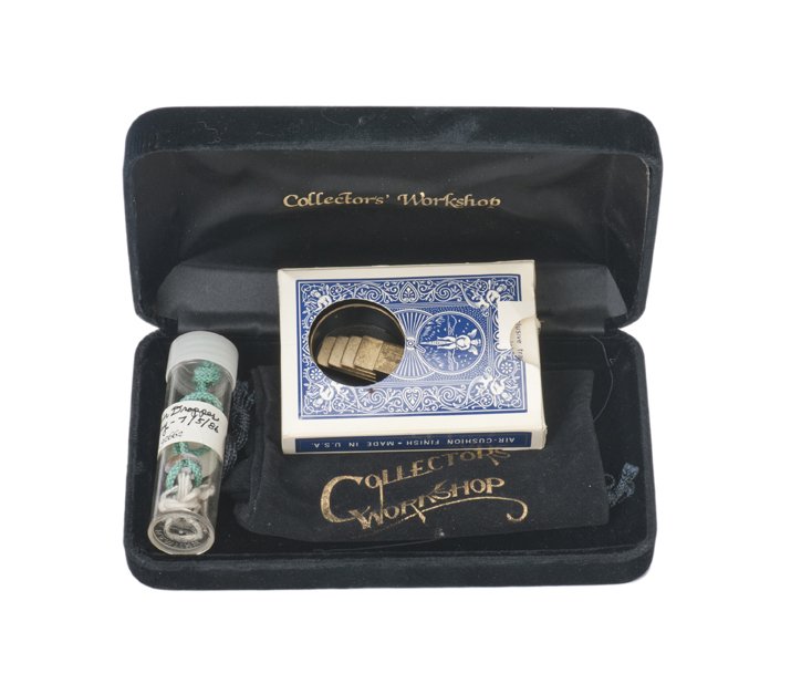CW Coin Classic. Collectors’ Workshop, D.C. 1990: CW Coin Classic. Collectors’ Workshop, Washington, D.C., ca. 1990. A card case is balanced on an empty glass. Four coins are dropped into another glass that is covered by a handkerchief and placed o