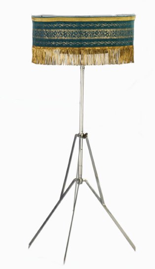 Magician’s side table. French, ca. 1925.: Magician’s side table. French, ca. 1925. Wooden top with green fabric cover trimmed in gold fringe (likely a modern replacements) and metal folding base. Unusual carved top with detachable cloth and