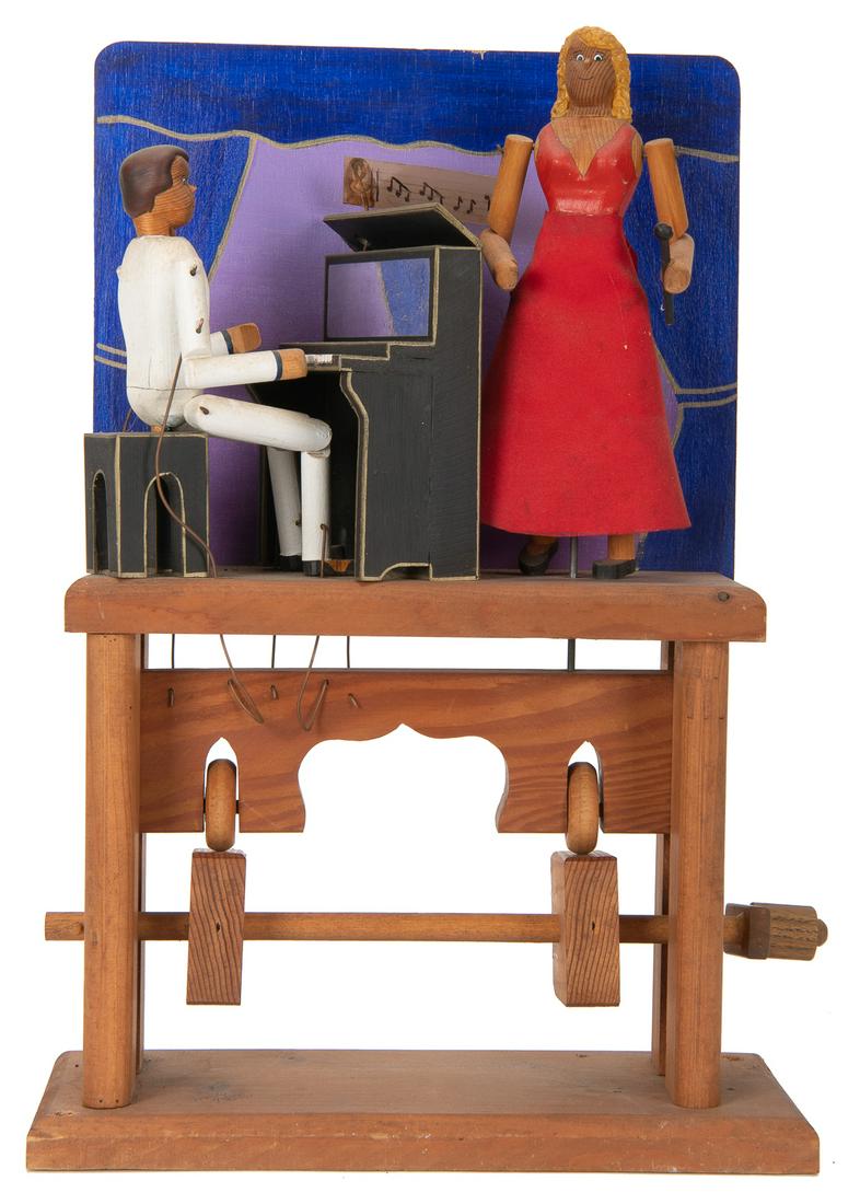 Jazz Bar Automaton. Atlanta: Mechanical Amusements, 1991. A...: Jazz Bar Automaton. Atlanta: Mechanical Amusements, 1991. Automaton of a couple performing on stage. The woman wears a red dress, holding a microphone while the man sits on piano, donning a white suit