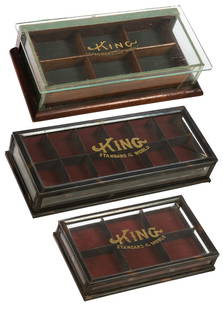 Group of Three Countertop Display Cases for King Standard o...: Group of Three Countertop Display Cases for King Standard of the World Collar Buttons. Circa 1900s. Two Japanned tin and glass display cases and one wooden and glass display case, each with a decal on