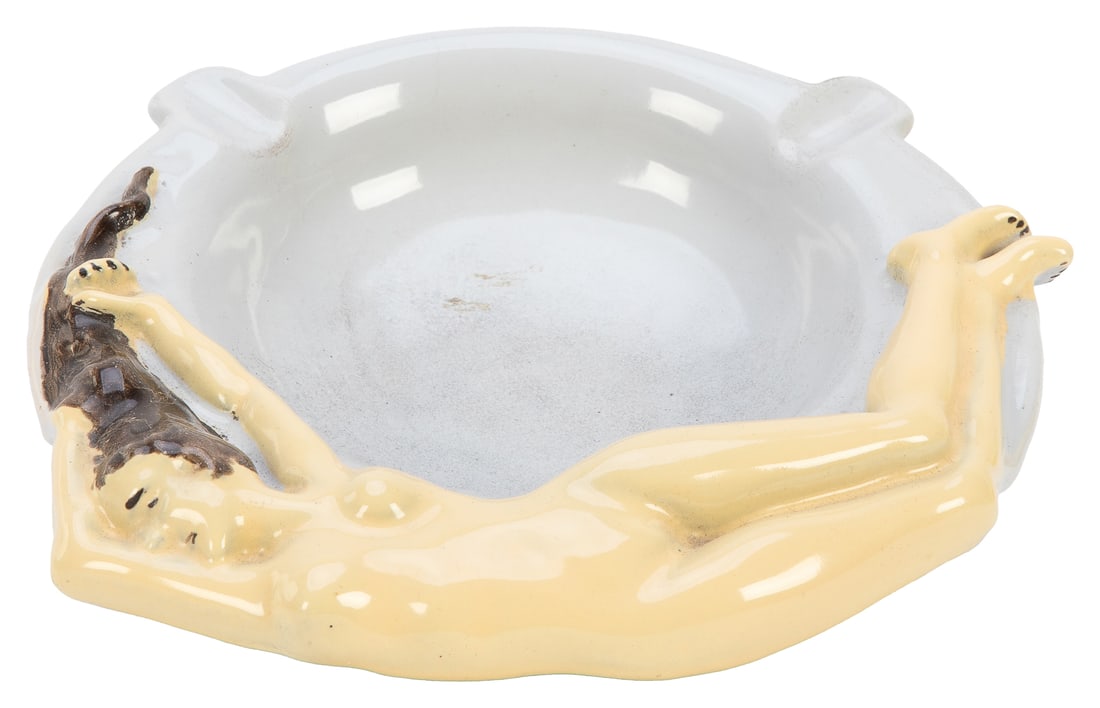 Nude Enamelware Ashtray. Heavy enameled cast iron ashtray d...: Nude Enamelware Ashtray. Heavy enameled cast iron ashtray depicting a female nude. Diameter 7”. Few slight marks to surface.