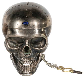 Silver Skull Desk Clock. Continental, 19th century. Silver ...: Silver Skull Desk Clock. Continental, 19th century. Silver skull/memento mori desk clock with crossbones support, having an enamel face, semi-precious stone inset functioning as button clasp. Key-woun