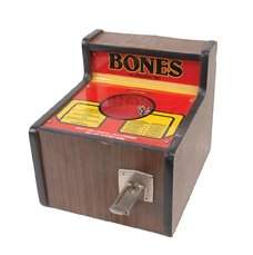 “Bones” 25-cent countertop slot machine. 1988: “Bones” 25-cent countertop slot machine. Gamemasters, 1988. Three dice are spun by the machine on each play; their total determines the payout. 16 x 13 x 13”. Fair condition.