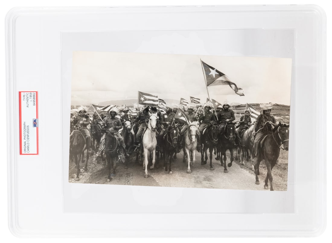 [CUBAN REVOLUTION]. CINFUEGOS, Camilo (1932-1959). Original...: [CUBAN REVOLUTION]. CINFUEGOS, Camilo (1932-1959). Original News Service Photograph by Raul Corrales Fornos (not credited) of Cinfuegos on Horseback Leading Cuban Revolutionaries (Campesinos) with Cub