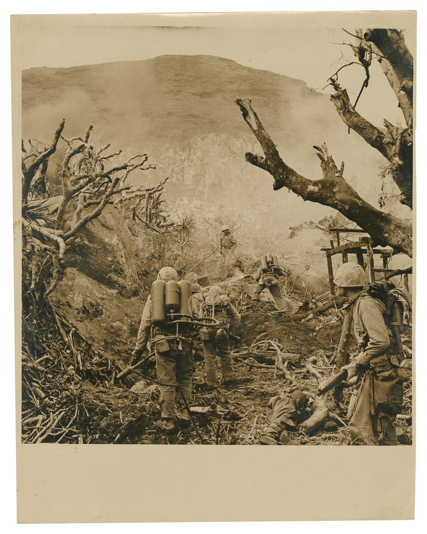 [WWII]. Oversized press photograph of Iwo Jima for Yank The...: [WWII]. Oversized press photograph of Iwo Jima for Yank The Army Weekly. Circa 19 February - 26 March 1945. Glossy sepia tone photo (356 x 279 mm), press stamp and penciled notation on verso, some bro