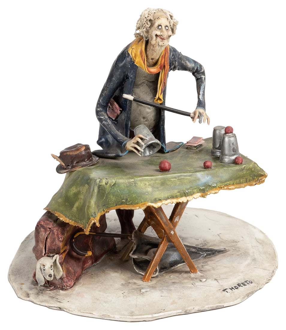 MORETTO, Toni (Italian, 1929-2011). Street Magician. Italy:...: MORETTO, Toni (Italian, 1929-2011). Street Magician. Italy: Lo Scricciolo, 1980s. The conjurer stands behind the trestle-like table presenting the Cups and Balls; he holds a wand in one hand and a cup