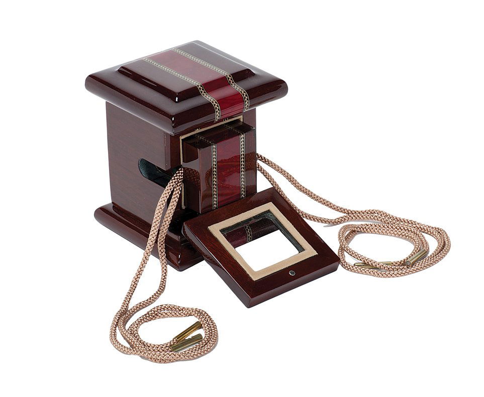 Chiang Mai Block. Thailand, Magic Wagon, 2007.: Chiang Mai Block. Thailand, Magic Wagon, 2007. An ornate wooden block is suspended on a thick cord, and then placed in an equally ornate cabinet. The cords are then pulled free of the block and cabine