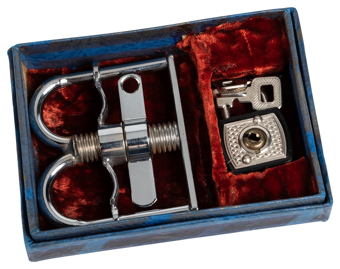 Thumb Cuffs. Vienna: Klingl, 1950s. Finely made chrome plat...: Thumb Cuffs. Vienna: Klingl, 1950s. Finely made chrome plated restraint for the thumbs with central screw for tightening. With original lock, keys, and paper-covered box lined with plush. Height 2 