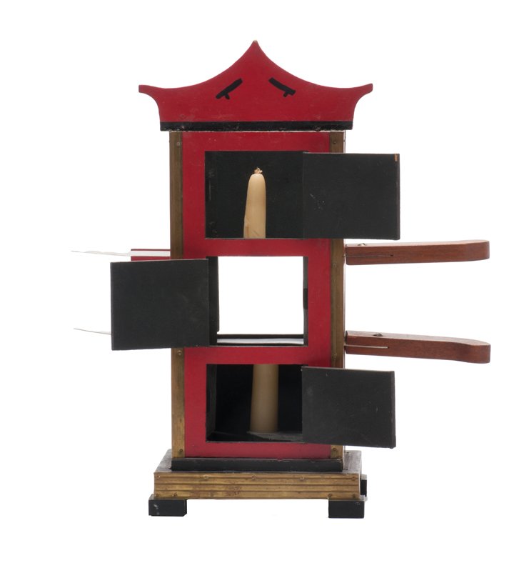 Ed Massey Flame Clock: Chinese Flame Clock. Ardmore Pennsylvania, Ed Massey, ca. 1958. A lit candle in an upright cabinet is bisected by two swords. When doors in the front and rear of the cabinet are o pened, the candle ca
