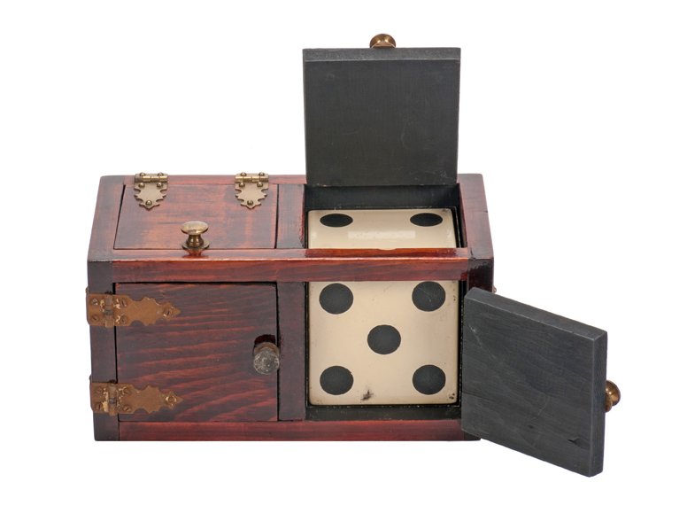 P & L Die Box: Die Box. New Haven Connecticut, Petrie and Lewis, ca. 1939. Wooden box from which a die vanishes, only to reappear elsewhere. With shell, double door, and solid die. 7 ½ x 4 x 4”. Shell and box scu