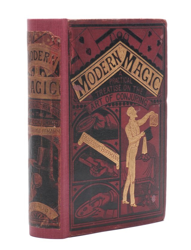 Hoffmann, Professor. Modern Magic. First edition.: Hoffmann, Professor. Modern Magic. London: George Routledge and Sons, 1876. First edition, first state (black hat, gold cone). Red cloth stamped in black and gold. Engraved frontispiece. With 318 illu