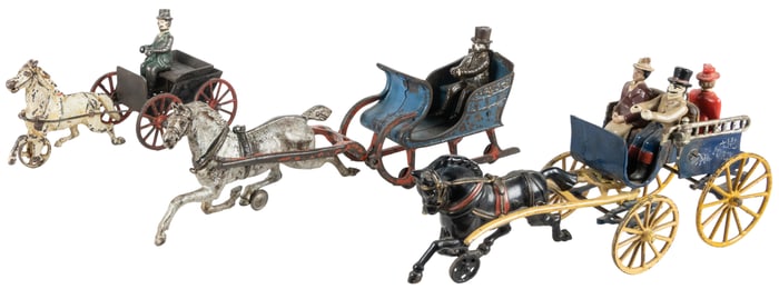 Two Cast Iron Horse Drawn Carriages and One Sleigh. One car...