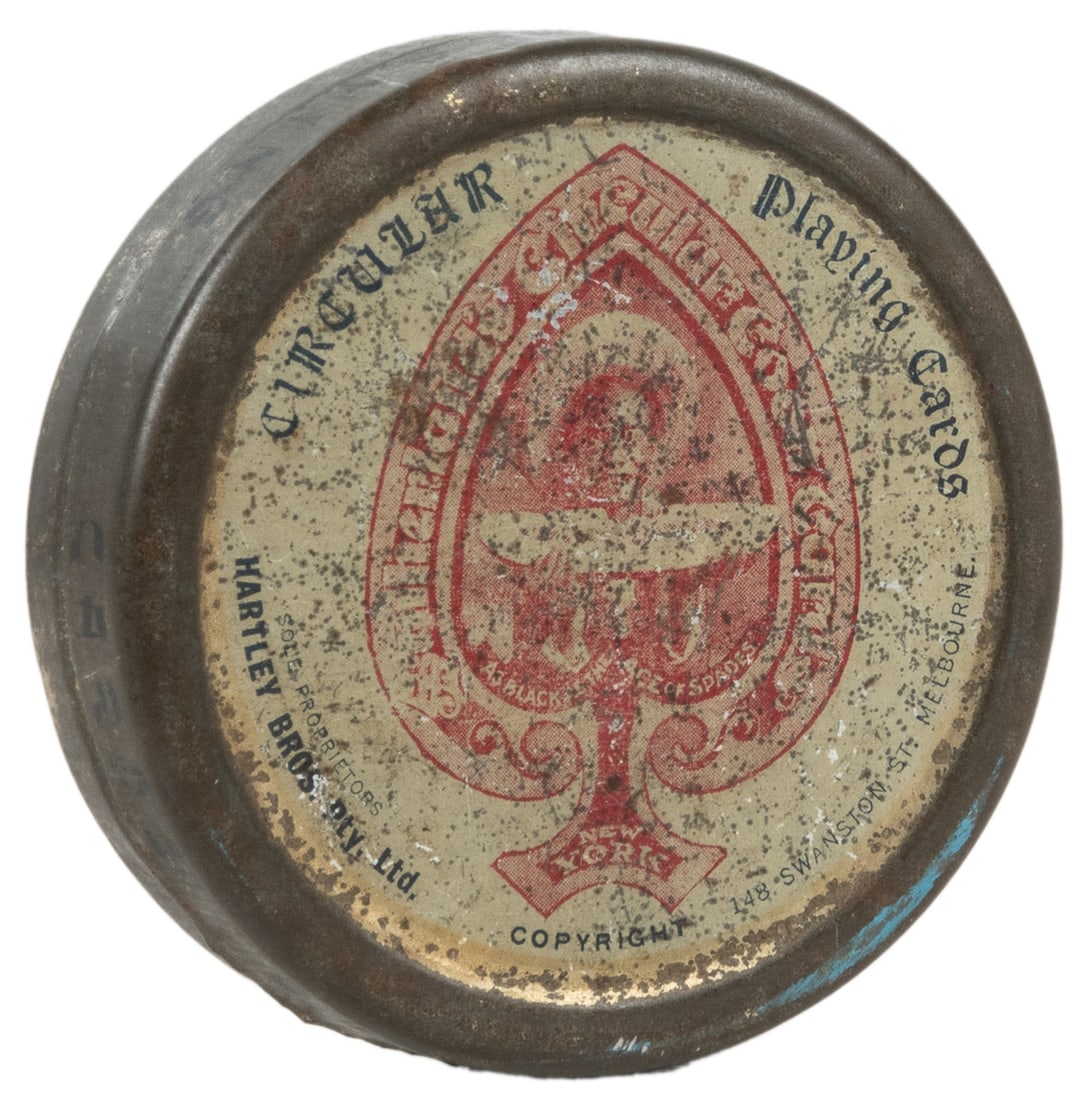 Sutherland’s Circular Coon Cards. Black as the Ace of Spade...: Sutherland’s Circular Coon Cards. Black as the Ace of Spades. Melbourne: Hartley Bros., 1885. Circular playing cards enclosed in the original tin box with label. Scrapes and darkening to tin, ot