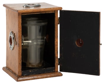 Milk Penetration Cabinet. Circa 1920s. A tumbler filled wit...