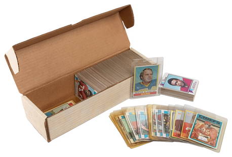 Box of 1970s Football Cards. Card storage box (length 13”) ...: Box of 1970s Football Cards. Card storage box (length 13”) approximately 75% full, most 1973 and 1974 Topps. 20 cards in sleeves, all others loose. Not indiaivually inspected, overall good colle