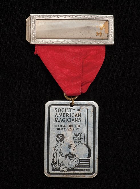 Cardini’s S.A.M. Convention badge. New York, 1939.: Cardini’s S.A.M. Convention badge. New York, 1939. Handsome engraved badge bearing an illustration by Gerald Lynton Kaufman for the 11th annual Society of American Magicians convention, held in New 