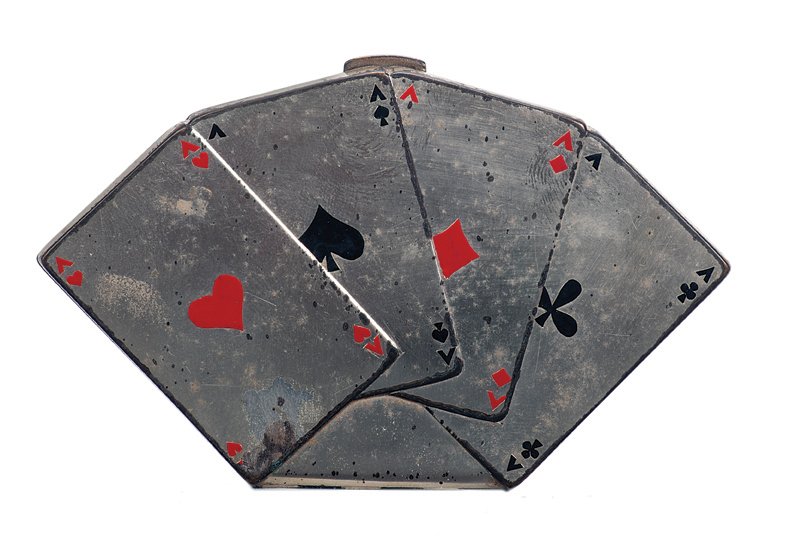 Swan Cardini’s card fan compact.: Swan Cardini’s card fan compact. Hinged metal make-up compact fitted with mirror, resembling a fan of four aces (fronts and backs). Owned and used by Swan Cardini. 4” wide. Metal spotting; fair.