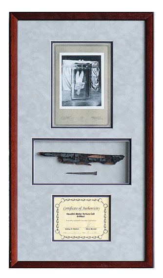 Houdini’s Water Torture Cell Fragment.: Houdini’s Water Torture Cell Fragment. Being a charred slab of wood and one nail from Houdini’s original and most famous escape device, the Water Torture Cell. The Cell, which burned in a fire at 