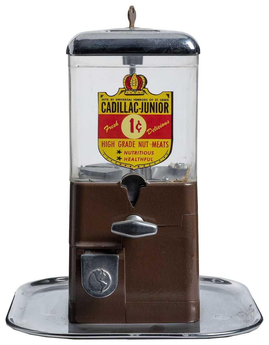Universal Cadillac Junior 1 Cent Tray Vendor. Universal Ven...: Universal Cadillac Junior 1 Cent Tray Vendor. Universal Vendors of St. Louis, ca. 1950s. Brown painted body affixed on tray, plastic globe with replica decal. Height 10 ¼”. With lock and ke