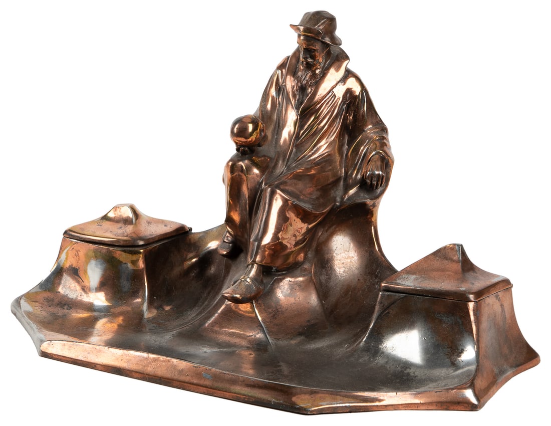 Memento Mori Inkwell. Germany: J.P. Kayser, ca. 1900s. Copp...: Memento Mori Inkwell. Germany: J.P. Kayser, ca. 1900s. Copper-plate inkstand, with a design often attributed to Hugo Leven, depicting a bearded man studying a skull. Inkwells with glass inserts (one c
