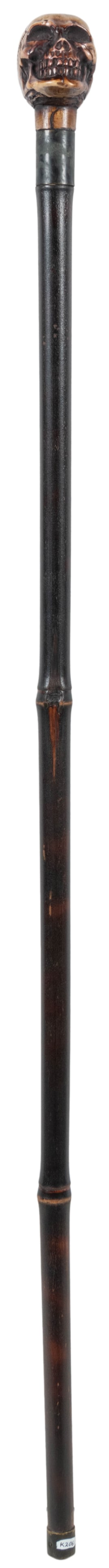 Carved Skull Sword Cane. Carved and polished wooden skull h...: Carved Skull Sword Cane. Carved and polished wooden skull handle, with blade hidden in the body. Minor scrapes to wooden body. From Ken Klosterman’s Salon de Magie. Length 35”.