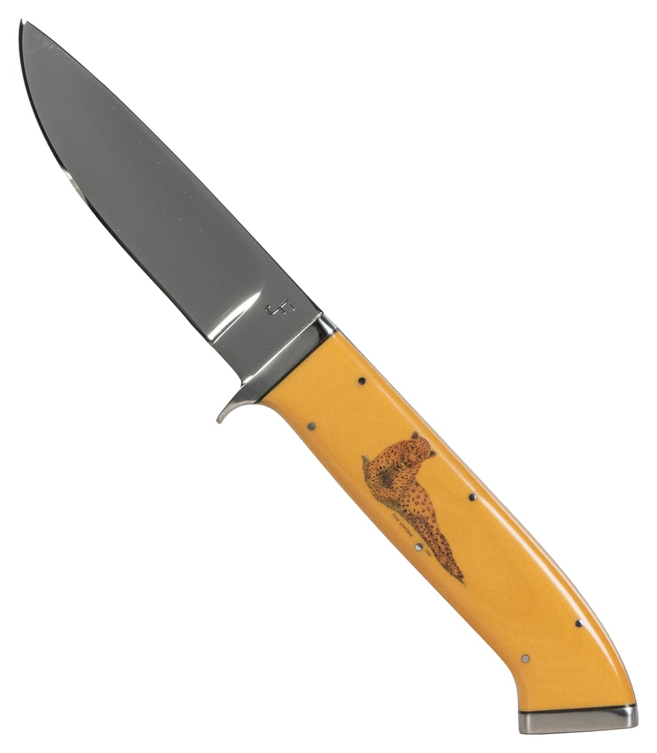 JF “099” Fixed Blade Knife. United States. Full tang, mirro...: JF ”099” Fixed Blade Knife. United States. Full tang, mirror finished fixed blade. Full tang. Scrimshaw of a cheetah by Dick Hanson, 1981. Nickel silver front and rear bolster with natural