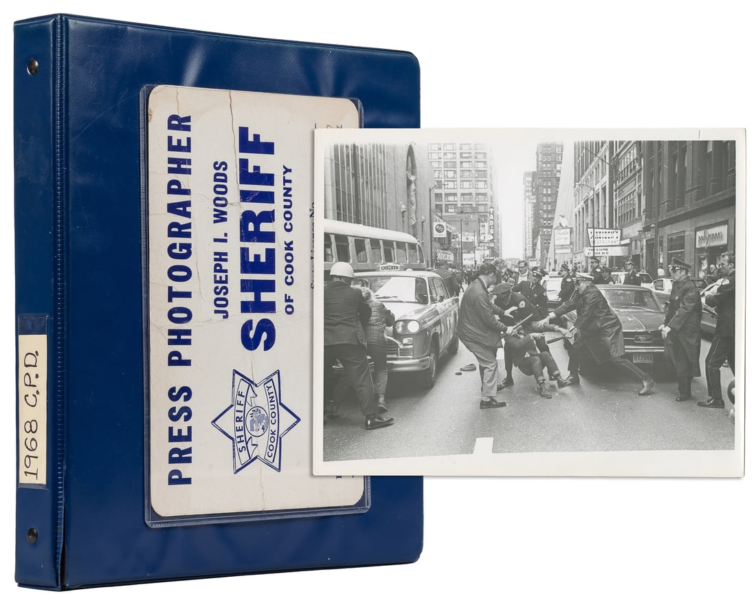 [DAYS OF RAGE]. Over 30 photographs of the protests in Chic...: [DAYS OF RAGE]. Over 30 photographs of the protests in Chicago. [Chicago, 1969]. Thirty-five glossy black and white photographs (8 x 10”), and one reprint photo, in blue vinyl binder with Cook C