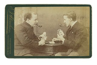 Carte de Visite of Two men Playing Cards. ca. 1890: Carte de Visite of Two men Playing Cards. London, ca. 1890. The cards have no indices, therefore dating the photo to ca. 1890. The two men are smoking pipes and playing on a very fancy table. They are